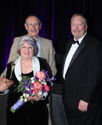 Bohnne Jones and her husband Larry (behind her) with James S. Bugg, Jr., Decorating Den Interiors president and CEO.