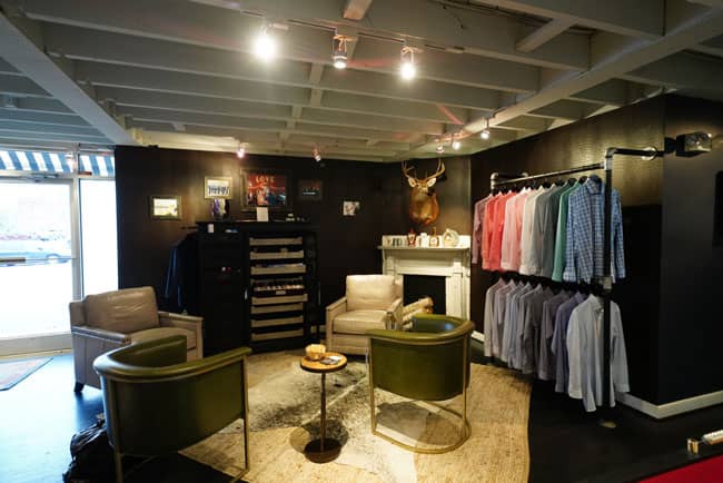 The Alton Lane showroom featuring its clothing and Universal Furniture leather furnishings.