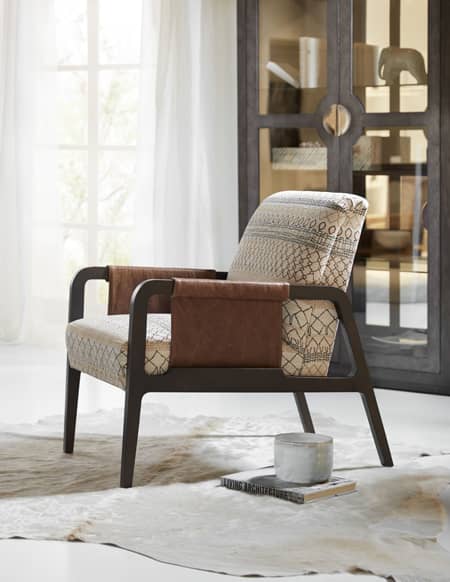 The Arrow chair features an exposed wood arm with a customizable sling-style wrap. Shown here in Sam Moore’s Global Chic lifestyle trend, this nomadic theme features fresh colorations in a woven tribal pattern.