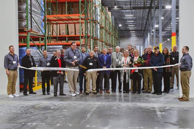 Executives and warehouse workers gathered with community leaders to celebrate the grand opening and ribbon. Photo Credit: Joshua A. Barnett