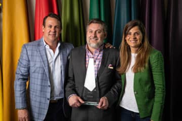 Pictured is Rico Berrios, VP of Sales; Tom Hall, Brand Ambassador of the Year; and Veronica Schnitzius, President.