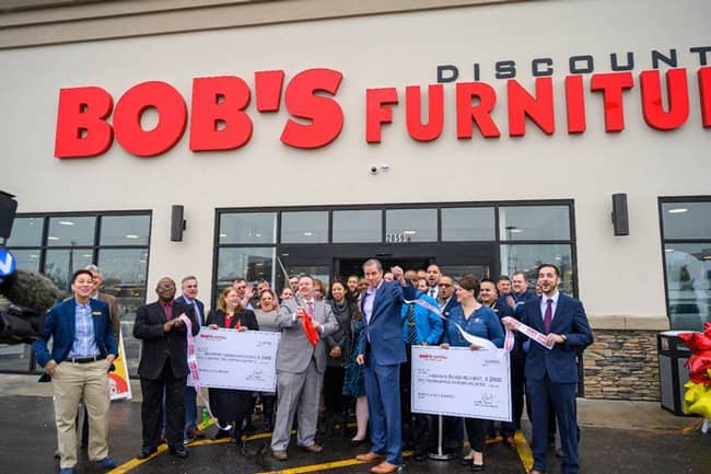 Pictured L to R: Matthew Goode, store manager, cuts the ribbon at the new Bob’s Discount Furniture location in Dayton, OH.