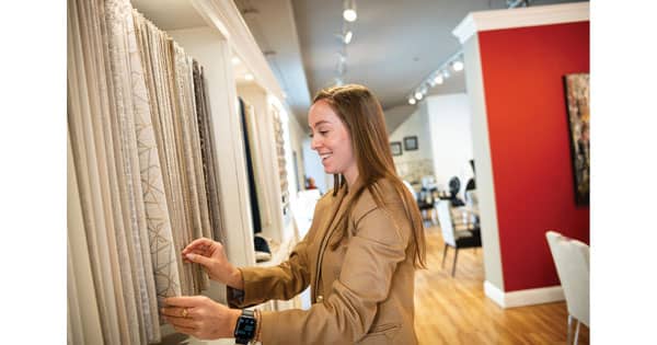 This is the first time HPU junior Alexis Haas has worked at the High Point Market with DesignMaster Furniture, which focuses on interior design for dining spaces. Haas helped clients decide which finishes or fabrics they’d want for their products.